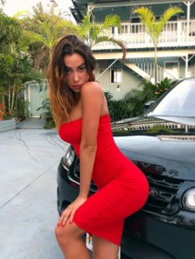 Valentina Fradegrada posing for a photo with car