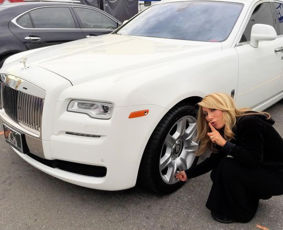 Lori Greiner posing for a photo with car