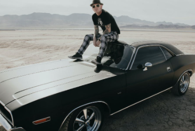 Corey Taylor posing for a photo with car
