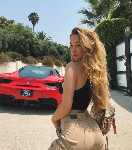 Savannah Montano posing for a photo with car 