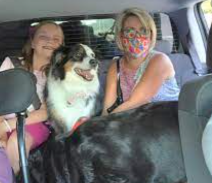 Kelly L. Frey sitting inside the car with her family