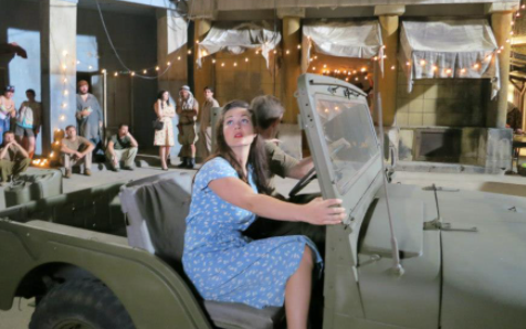 Stephanie Beran posing for a photo with car