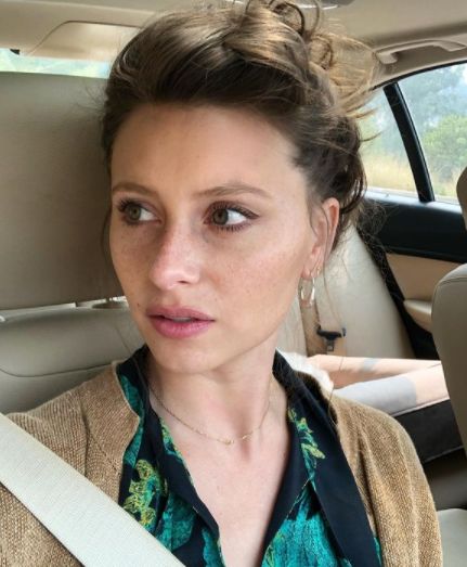 Alyson Michalka posing inside her car