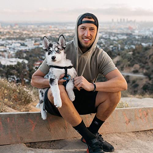 Mike Majlak posing for the photo with his dog 
