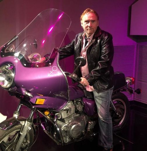 Amy Railsback's husband, Danny Bonaduce posing with his bike