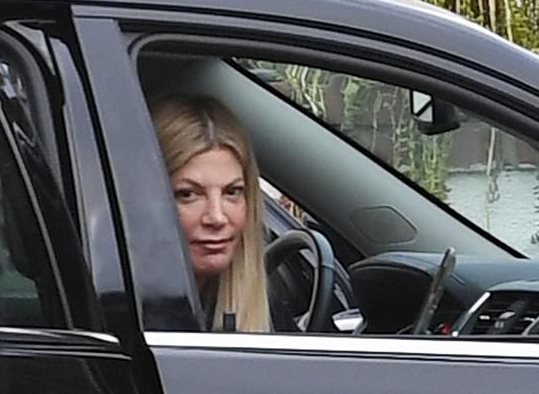 Charlie Shanian's ex-wife, Tori Spelling posing with her car