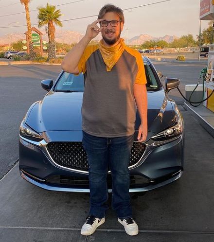 Colt Johnson posing with his car