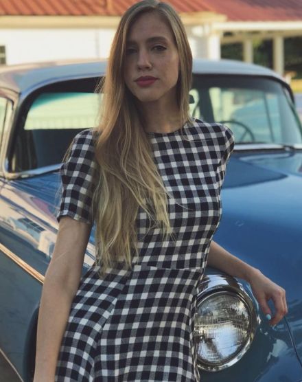 Heidi Feek posing with her car