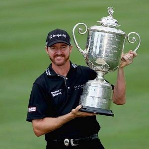 Erin Stiegemeier's husband Jimmy Walker psoing for the phot with the cup 