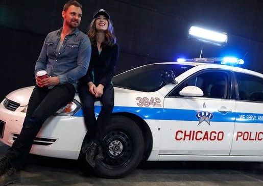 Reem Amara's boyfriend, Partick Flueger and his co-actor posing with a police car