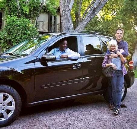 Tana Mundkowsky and her husband, Brandon Flowers posing with their car
