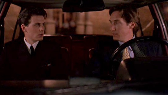 Taylor Nichols and his co-star posing inside the car