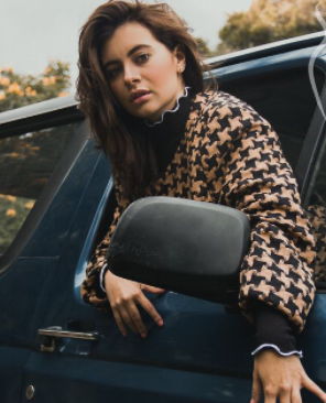 Natalia Tellez posing for a photo with car