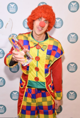Roman Atwood posing for a photo with award