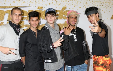 Christopher Vélez with his CNCO band members 