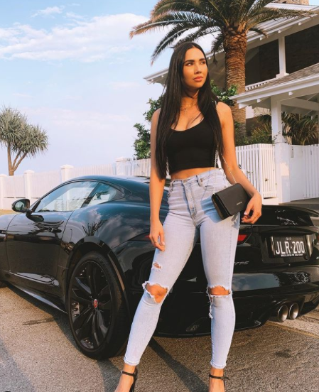Jessica Green posing for a photo with car 