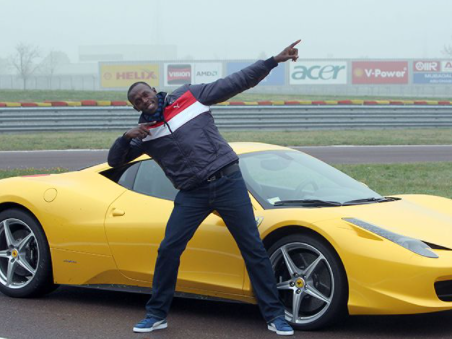 Justin Gatlin posing for a photo with car