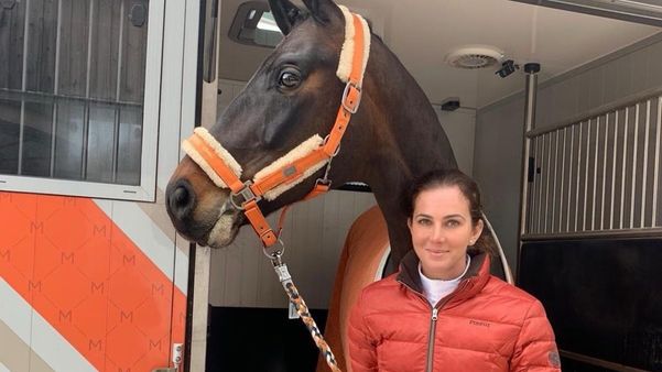 Lisa Muller posing for the photo with her horse