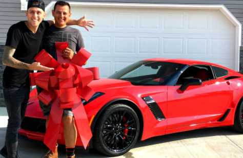Curtis Dale Atwood II with hsi son posing for a photo with car