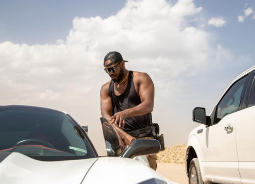 Jon Jones posing for a photo with car