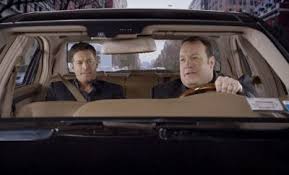 Gary Valentine sitting inside the car with his co-star