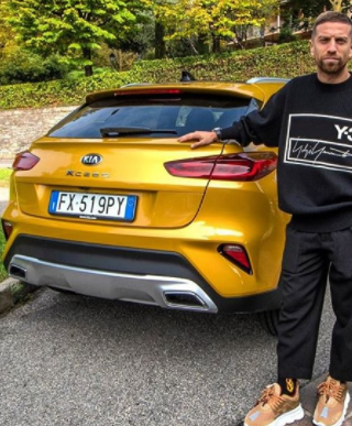 Alejandro Darío Gómez posing for a photo with car