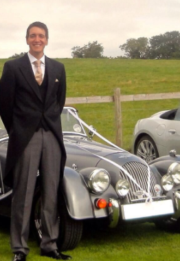Oliver Phelps posing for a photo with car