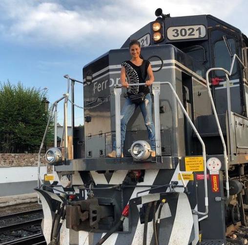 Sachi Tamashiro posing with a train