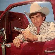 Chalino Sánchez posing for a photo with car