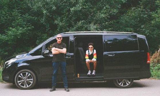 Tanya Reynolds and her co-actor posing with a van