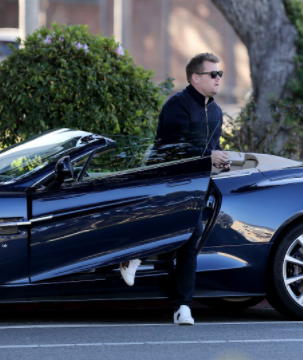 James Corden posing for a photo with car