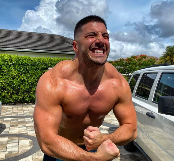 Nickmercs posing for a photo with his car