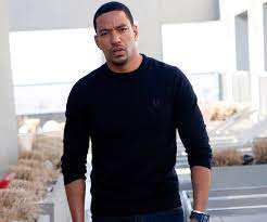 Caption: Laz Alonso posing for the photo 