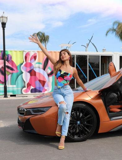 Bramty Juliette posing for a photo with her car