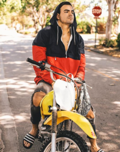 Adriano Zendejas posing for a photo with his bike