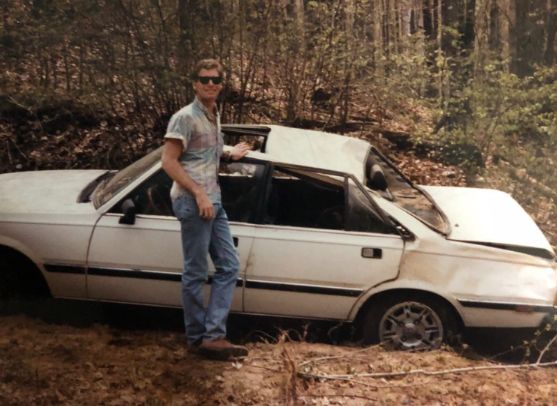 Adam F Goldberg posing with his car