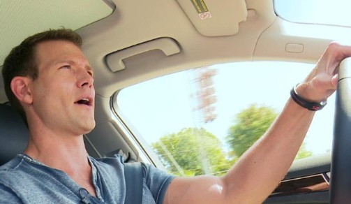 Charlotte Brown Stork's ex-husband, Travis Stork posing while driving a car