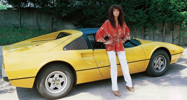 Kate Bush posing for a photo with her car