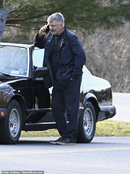 Alec Baldwi standing outside the car