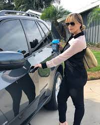 Rosie Rivera standing outside the car
