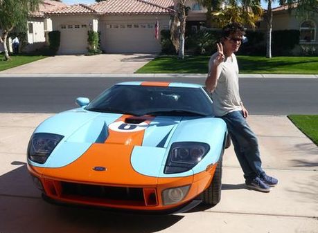 John Mayer posing with his car