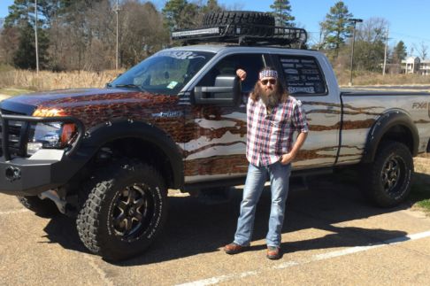 Merritt Robertson's uncle, Willie Robertson posing with his car
