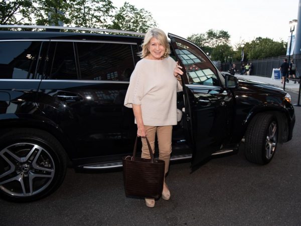Martha Stewart standing outside the car
