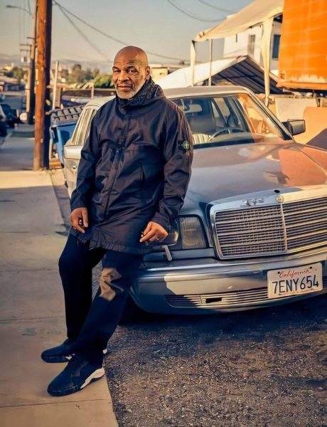Mike Tyson posing for a photo with his car