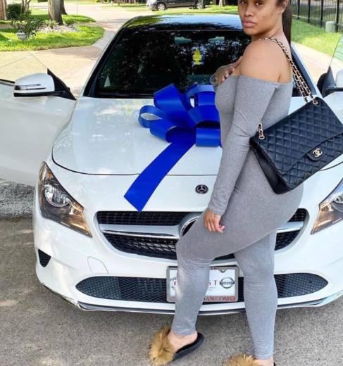 Summer Bunni posing with her car