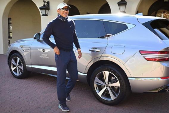 Tiger Woods posing with his car