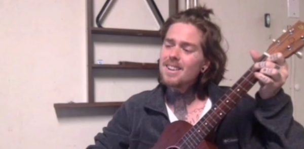 Christofer Drew playing with his guitar