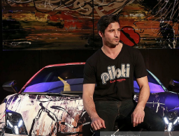 Jerald Bezener posing for the photo with the car