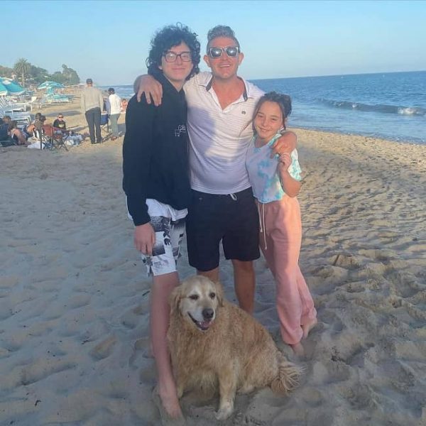  Jason Nash posing for a photo with his children and pet.