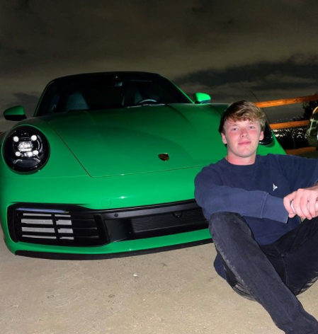 Daniel Macdonald posing for a photo with his car 